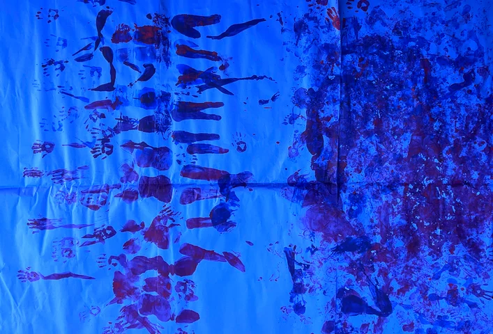 Handprints in deep blue and red on a blue ground
