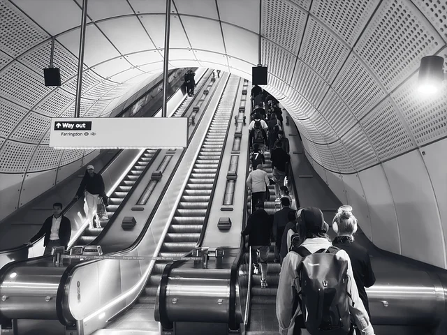 Black and white photograph of escalators in a London Underground station