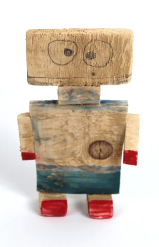 A small robot figure made from offcuts of wood