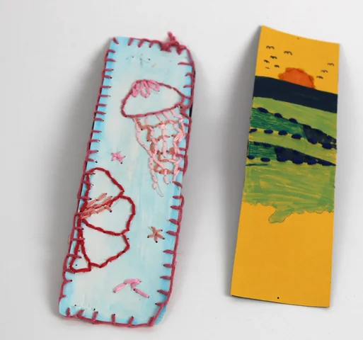 Two bookmarks, one embroidered with a jellyfish