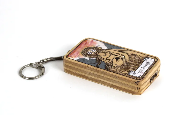 A wooden keyring with an illustrated panel
