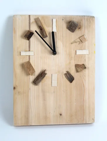A wall clock made from wood with offcut hour markers