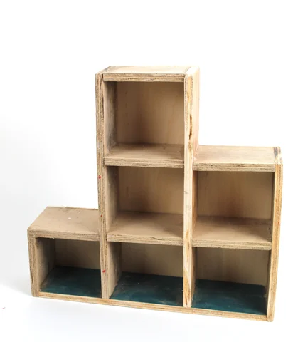 A stepped wooden shelving unit