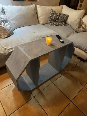 A hexagonal grey coffee table in a living room