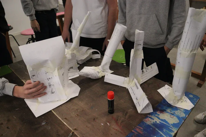 Several finished paper towers lined up for testing