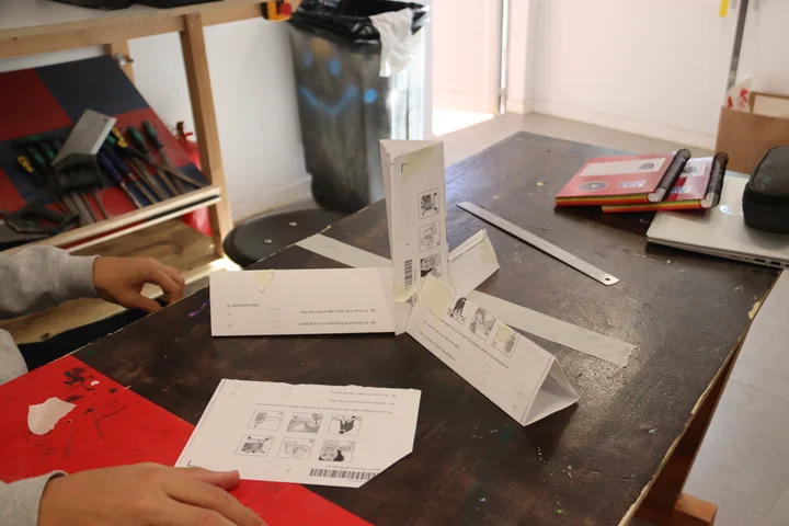 Design sheets and paper prototypes on a workbench