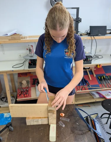 A student marking out a piece of timber in the workshop