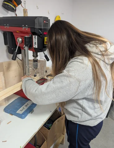A student using the pillar drill