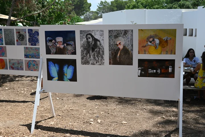 Portraits and photographs on an exhibition board
