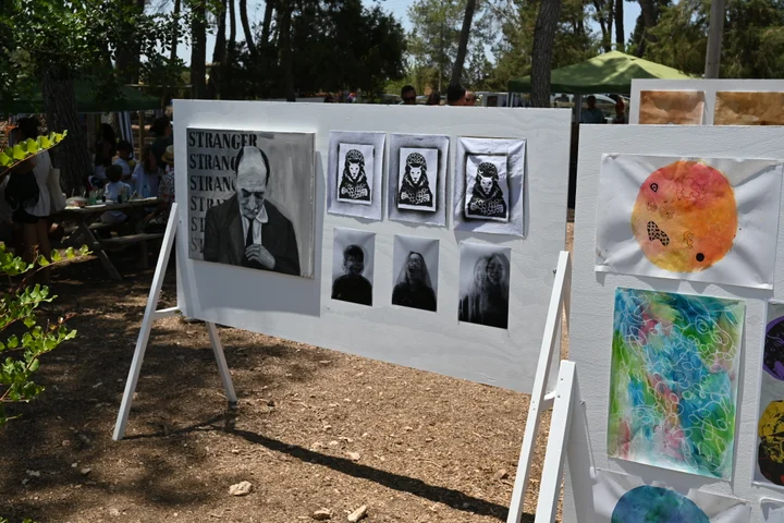 Black and white portraits beside colourful Primary work