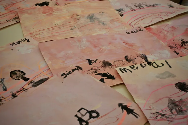 Painted backgrounds printed with black silhouettes of animals and vehicles, each with a child's name