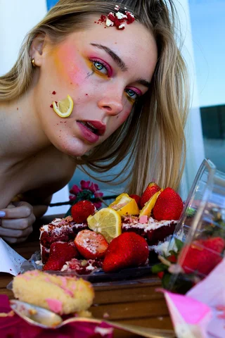 Portrait of a girl with decorated face and a plate of fruit