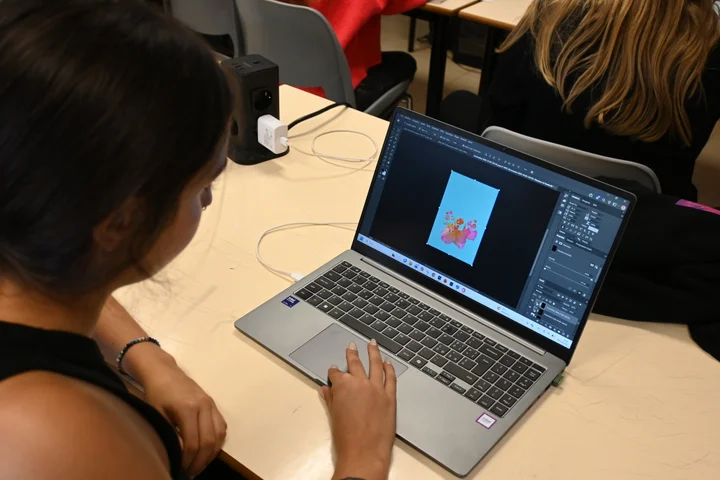 A student editing a photograph on a laptop