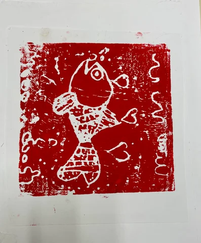 Red block print of a fish