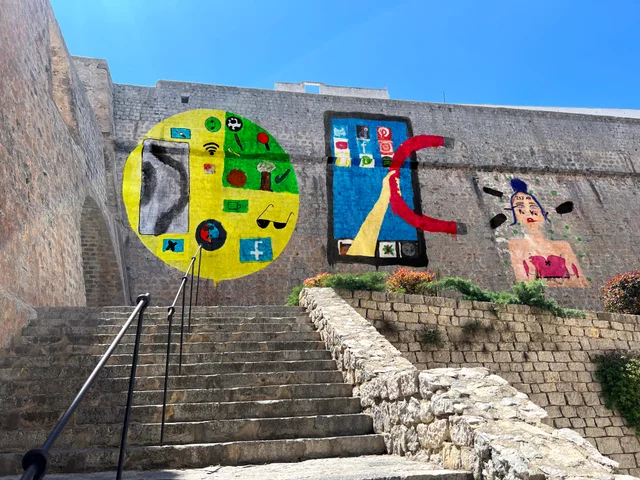 Student murals displayed on the walls of Dalt Vila