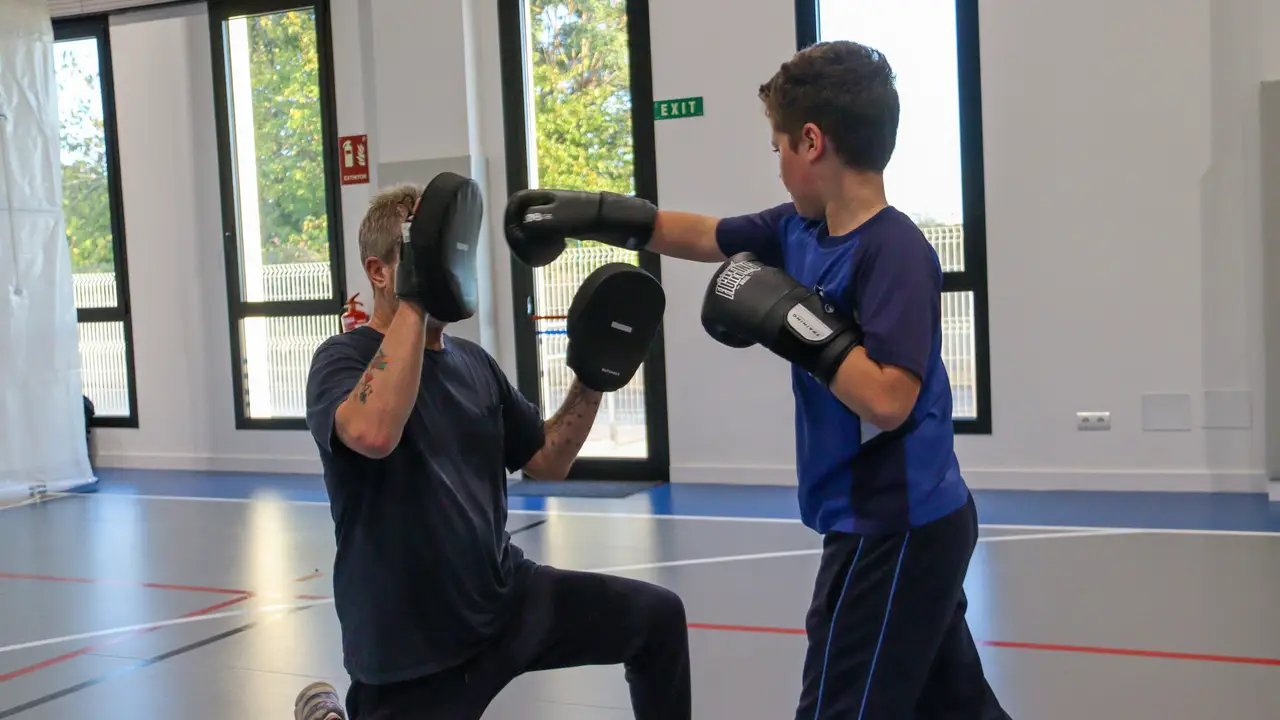 A Morna student boxing with a coach in the sports hall