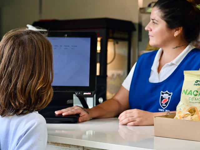 A pupil at the Snack Shack till while a member of staff serves