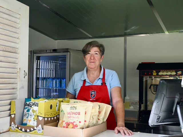 Mari behind the Snack Shack counter with a box of snacks