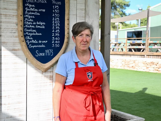 Mari beside the Snack Shack price board