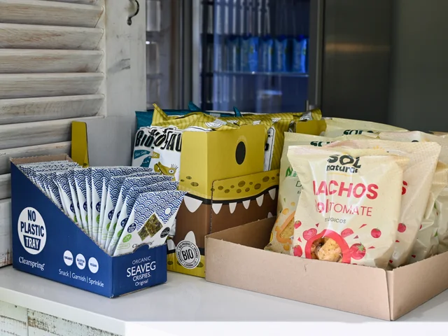 Packs of seaweed snacks and baked nachos on the counter