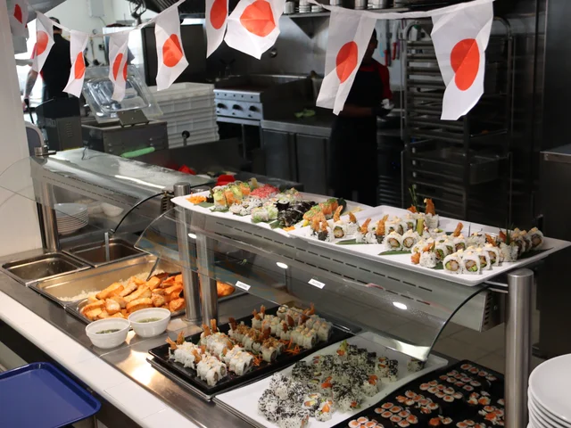 The buffet counter decorated with Japanese flags and lined with sushi trays