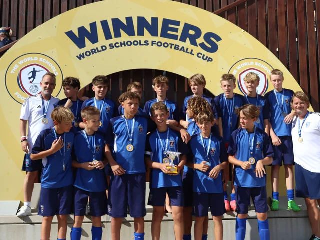 Morna's team with the World Schools Football Cup trophy and medals