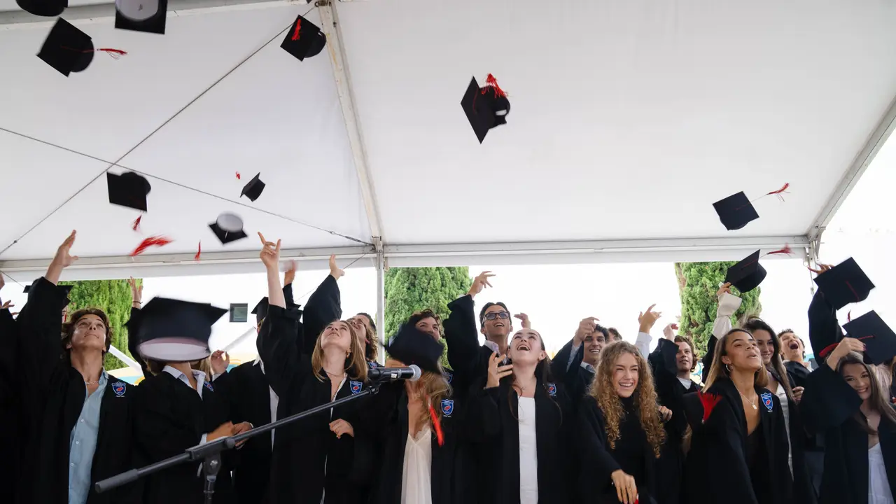 The Morna graduating class throwing their caps in celebration