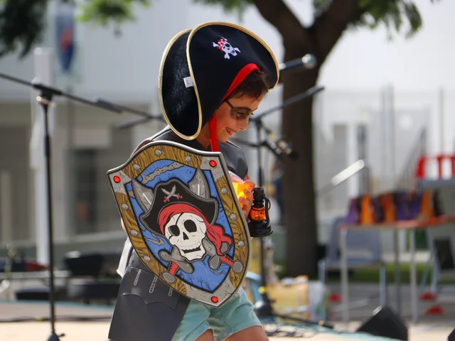 A Primary pupil dressed as a pirate with a skull-and-crossbones shield