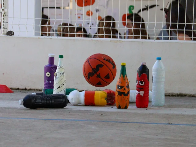 Bottles decorated as Halloween characters for a bowling game