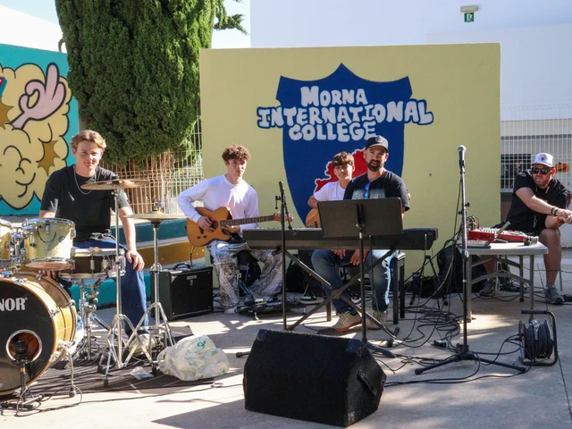 A student and staff band playing live in the playground