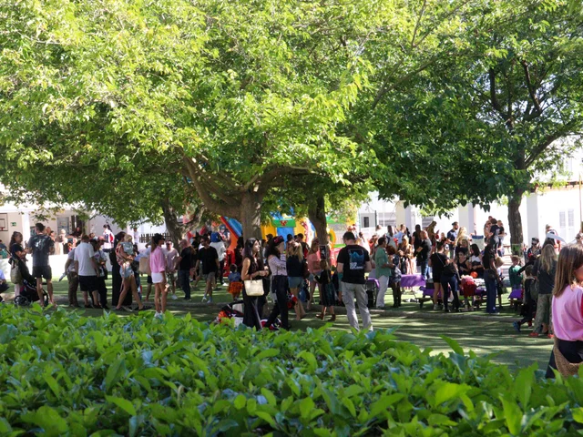 Families and students filling the campus under the trees