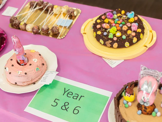 Easter cakes on the Year 5 & 6 table, one topped with a pink bunny