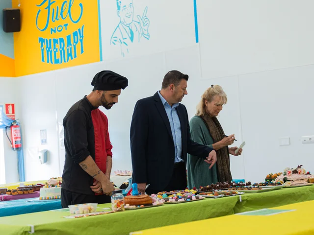 A chef and two judges looking over the Easter Bake Off entries
