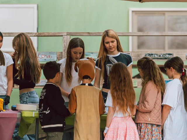 Primary children in costume lining up at the Easter cake stall
