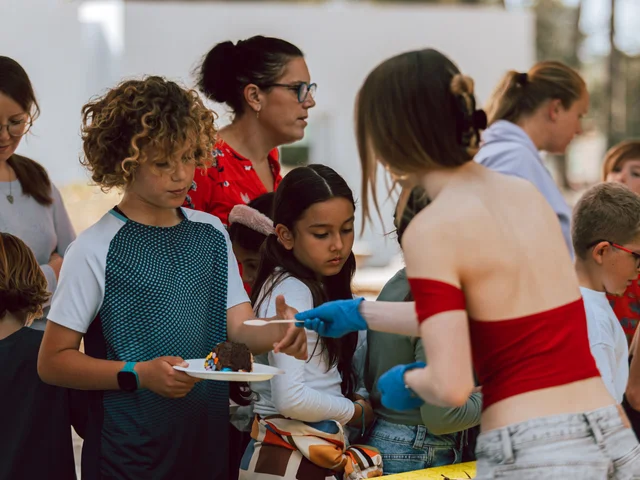 Children being served cake at the Easter Bake Off