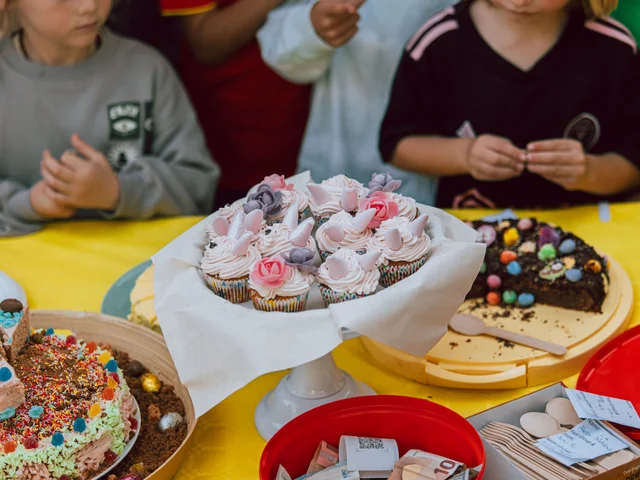 Children choosing from cupcakes and decorated cakes at Easter