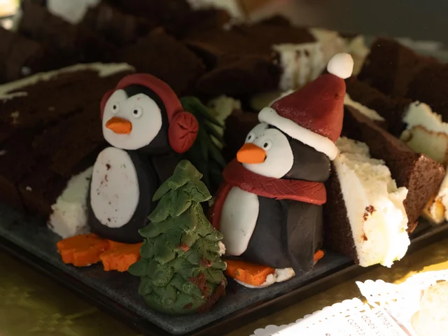 Brownies decorated with fondant penguins in Christmas hats