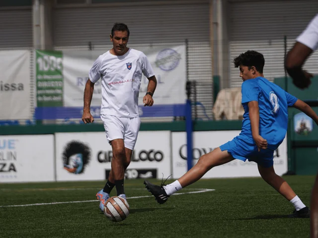 A special guest and a student competing for the ball