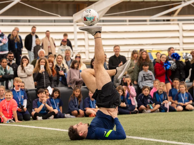 Joan Sitjar performing a freestyle trick in front of watching students
