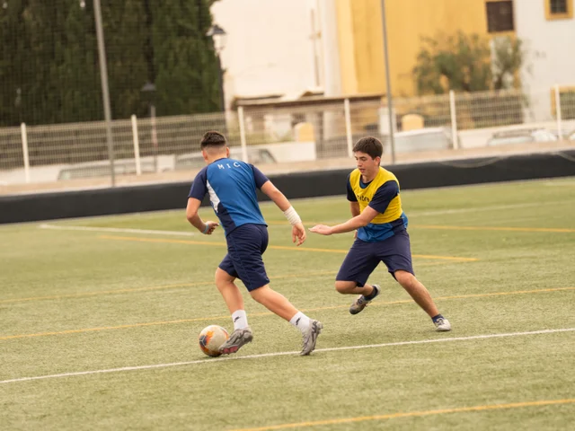 Two Secondary students contesting the ball