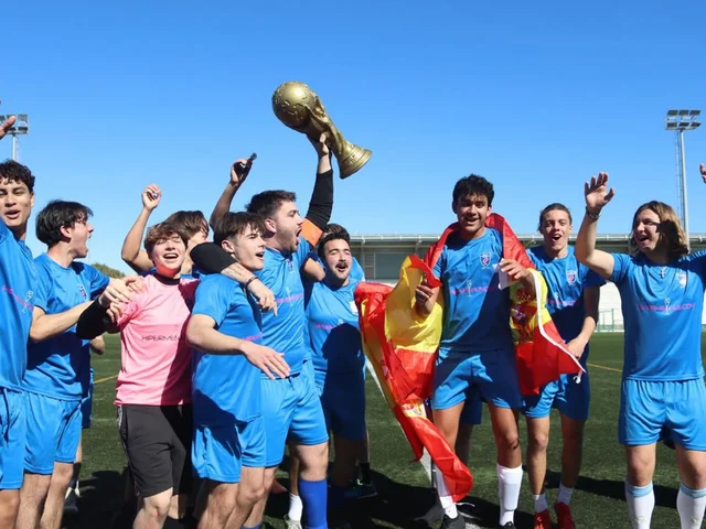 Sixth Form students celebrating with the trophy and a Spanish flag