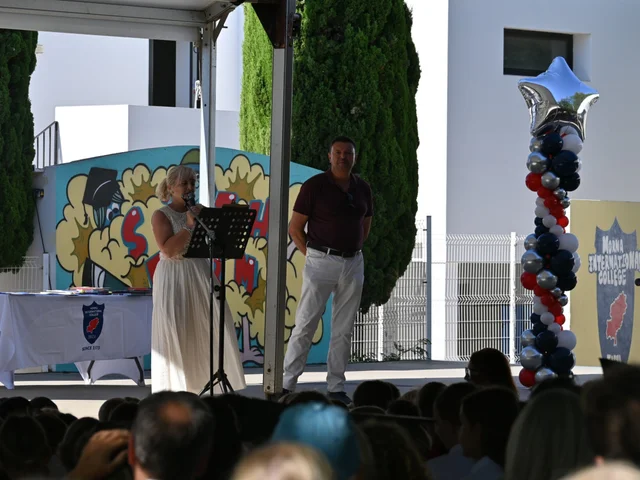 Staff hosting the end-of-year prize giving from the stage