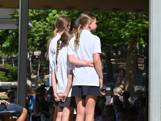 Pupils waiting at the side of the stage before their performance