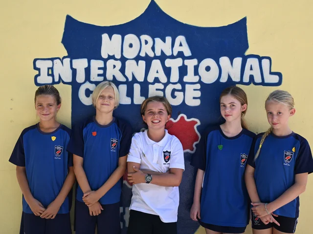 The Primary House Captains together in front of the Morna International College mural