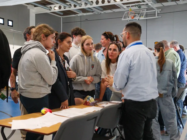Parents and students at an options fair stand
