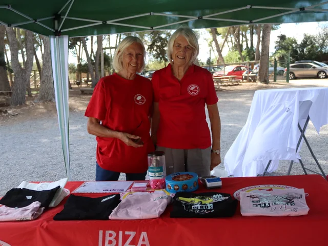 Two IFCC volunteers at their stall with the charity T-shirts