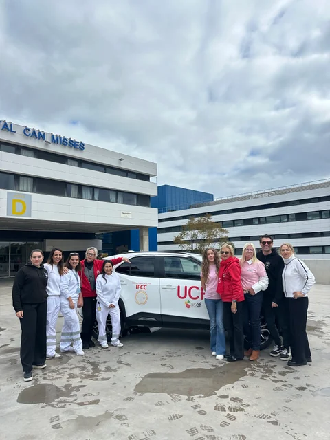 Carlie and Marta with IFCC members and the palliative care team beside the new car at Can Misses Hospital