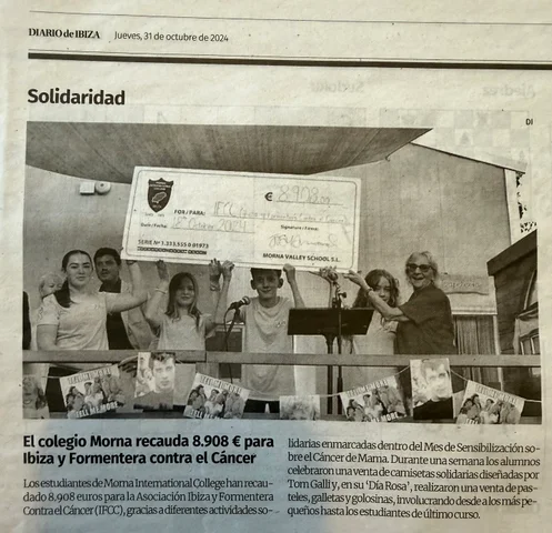 Diario de Ibiza, October 2024: students on stage holding the €8,908 cheque for IFCC