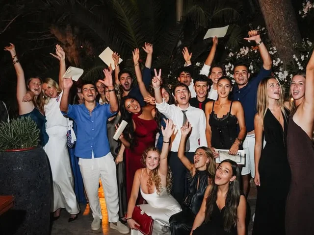 Year 13 students cheering with their arms in the air at prom night