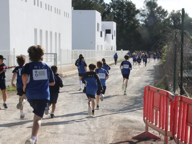Children in Action Against Hunger vests on the course